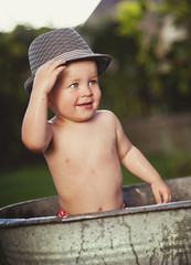 Little boy bathing outside