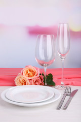 Table setting with pink rose on plate