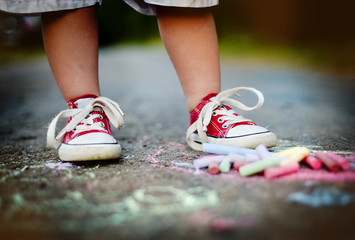 Close up of boy drawing with chalks