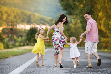 Happy family walking on road