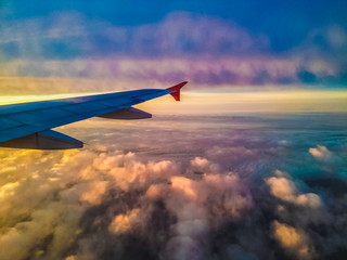 Fototapeta premium Wing of plane over the cloud