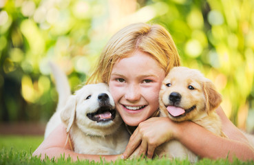 Cute Young Girl with Puppies