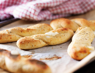 baked mozzarella breadsticks on parchment paper