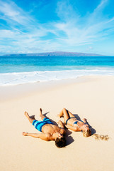 Obraz na płótnie Canvas Couple Relaxing on the Beach