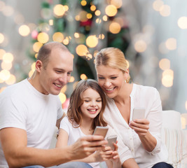happy family with smartphones