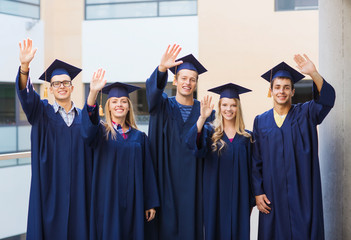 group of smiling students in mortarboards