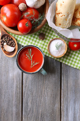 Homemade tomato juice in color mug, bread sticks, spices and