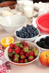 Baking tasty pie and ingredients for it on table in kitchen