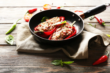 Delicious stuffed peppers in frying pan on table close-up