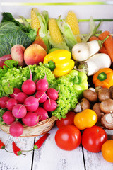 Vegetables in basket on white wooden box background