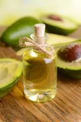 Avocado oil on table on light background