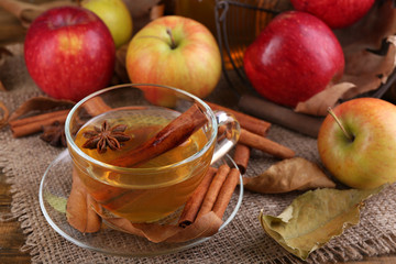 Composition of  apple cider with cinnamon sticks, fresh apples