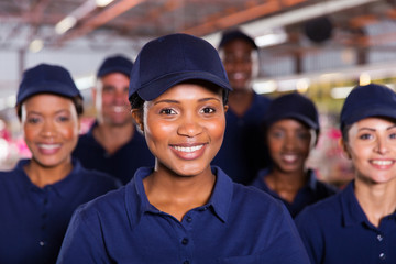 young african factory worker with colleagues