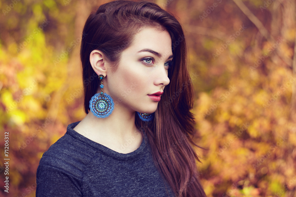 Wall mural portrait of young beautiful woman in autumn park