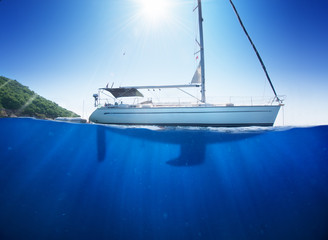 Sunlight seaview to sailboat in tropical sea with deep blue