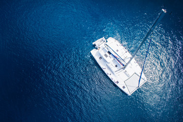 View to catamaran sailing in open sea at windy day. Drone view