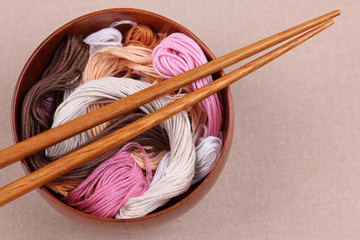 Cross-Stitch threads in a bowl with chopsticks