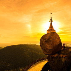 Kyaikhtiyo pagoda or Golden rock with sunset sky in Myanmar