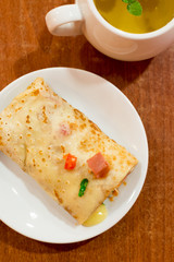 Pancake stuffed with meat and tea