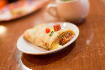 Pancake stuffed with meat and tea