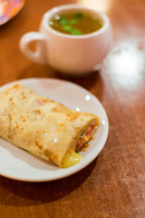 Pancake stuffed with meat and tea
