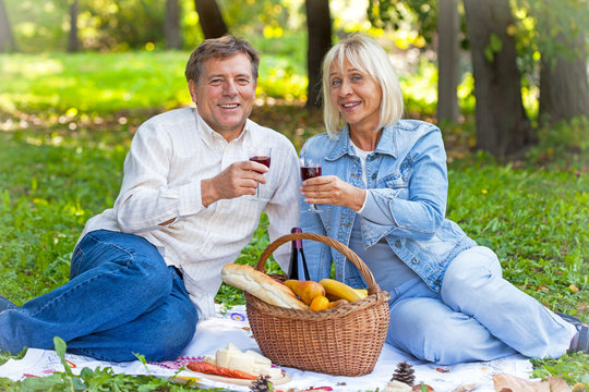 Mature couple laughing on a picnic