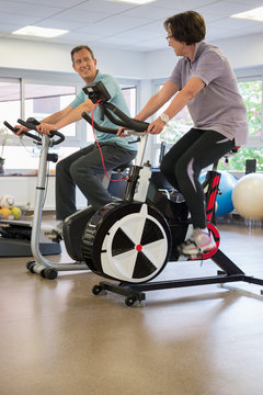 Man and woman in a spinning class at the gym
