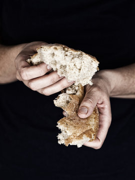 Woman's hands holding a pieces of bread