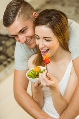 Couple eating fruit salad at breakfast