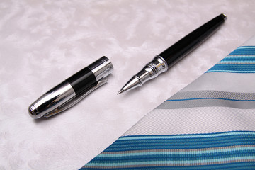 Business pen and tie composition background