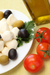 Mozzarella, olives, cherry tomatoes and olive oil.