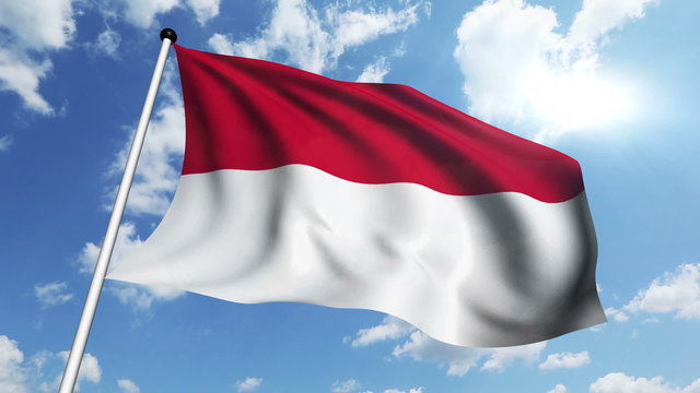 flag of Monaco with fabric structure against a cloudy sky