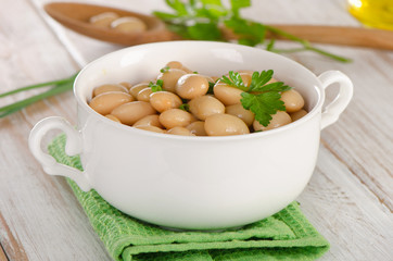 Beans with fresh parsley   on   wooden table.