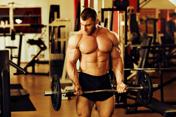 Fototapeta na wymiar bodybuilder training gym, standing barbell curl