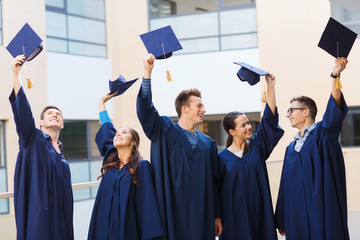 group of smiling students in mortarboards