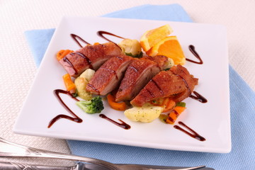 Roasted duck breast fillet, vegetables with orange