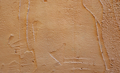 coarse brown plaster on the wall of the building