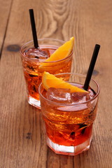 Spritz aperitif, two orange cocktail and ice cubes