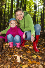 mother with her daughter doing mushroom picking