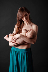 Fototapeta premium Mother breast feeding her infant