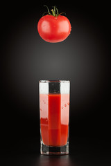 Tomato and tomato juice in a transparent glass faceted