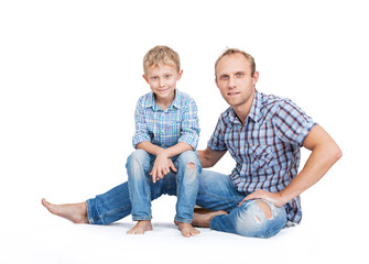 Father with son in old tattered jeans and plaid shirts on the wh