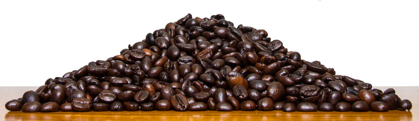 Roasted coffee beans laying on a pile of wood