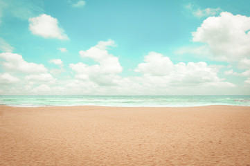 Sand beach, clouds and blue sky - retro color effect