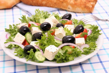Greek salad with gigantic black olives, sheeps cheese, bread