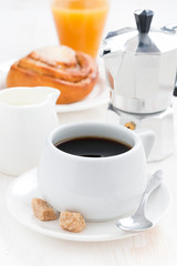 breakfast with coffee, sweet bun, fresh cream and orange juice