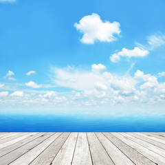 Wood plank as a pier on blue sky background