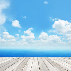 Wood plank as a pier on blue sky background