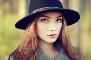 Portrait of young beautiful woman in autumn coat
