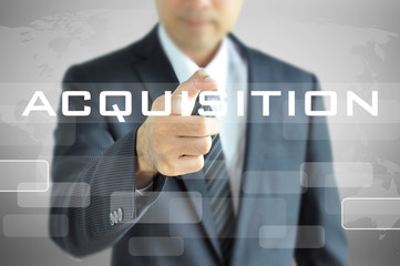 Businessman hand pointing on ACQUISITION word on virtual screen